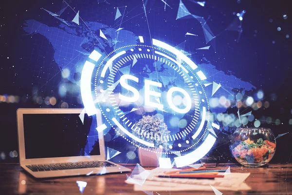 Double exposure of table with computer and seo drawing hologram. Search optimization concept. — Stock Photo, Image