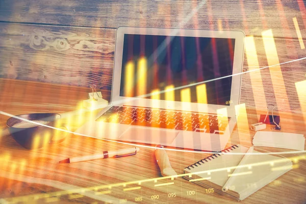 Financial graph colorful drawing and table with computer on background. Double exposure. Concept of international markets.