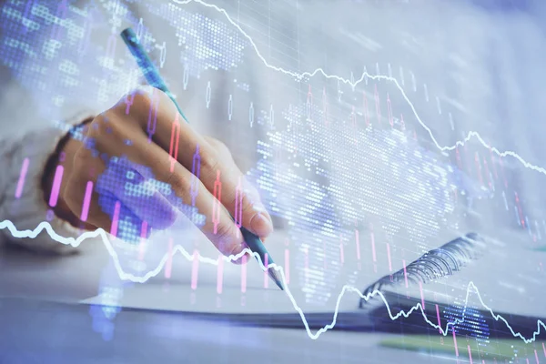 Financial forex graph displayed on hands taking notes background. Concept of research. Double exposure — Stock Photo, Image