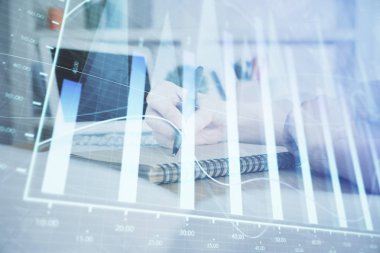 Finansal grafik WOMANS el notları arka plan alarak görüntülenir. Araştırma kavramı. Çift Pozlama