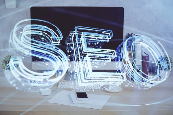 Double exposure of table with computer and seo drawing hologram. Search optimization concept. — Stock Photo, Image