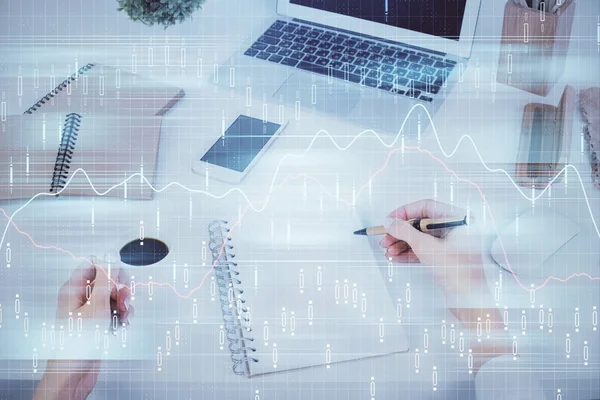 Hands writing information about stock market in notepad. Forex chart holograms in front. Concept of research. Multi exposure — Stock Photo, Image