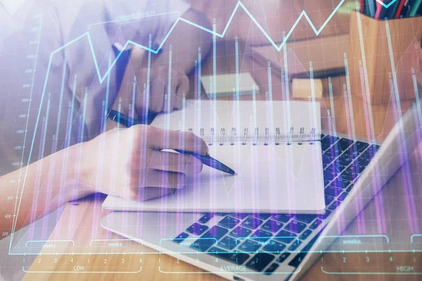 Financial charts displayed on womans hand taking notes background. Concept of research. Double exposure