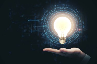 El ele tutuşarak parlayan ampul