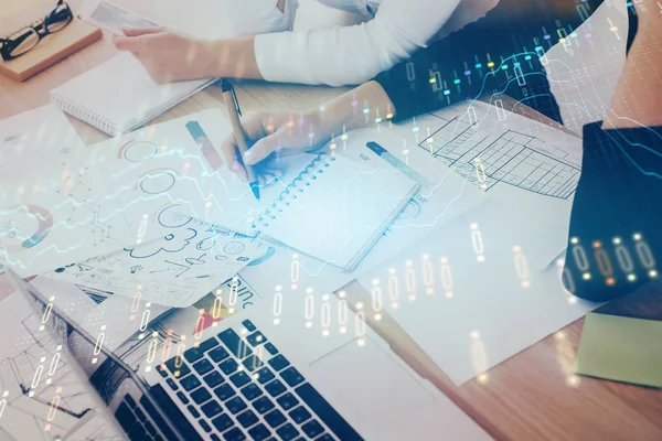 A woman hands writing information about stock market in notepad. Forex chart holograms in front. Concept of research. Double exposure — Stock Photo, Image