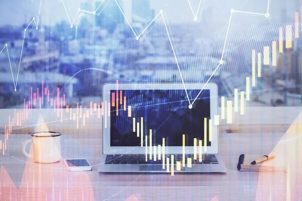 Financial graph colorful drawing and table with computer on background. Double exposure. Concept of international markets.