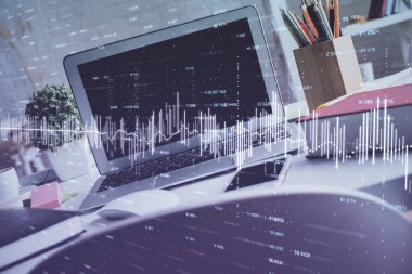 Finansal pazar grafiği hologramı ve kişisel bilgisayar arka planda. Çifte maruziyet. Önx kavramı.