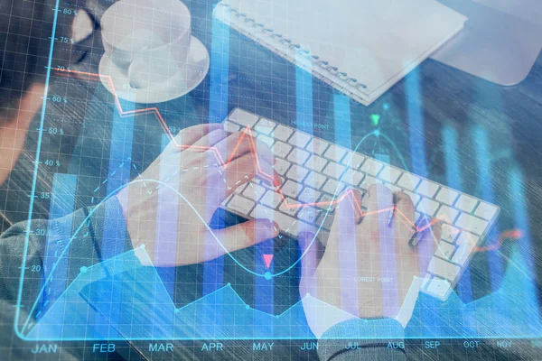 Double exposure of graph with man typing on computer in office on background. Concept of hard work. — Stock Photo, Image