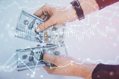 Finansal grafiğe çoklu pozlama hologram, Amerikan dolarları ve insan eli. Analiz kavramı.