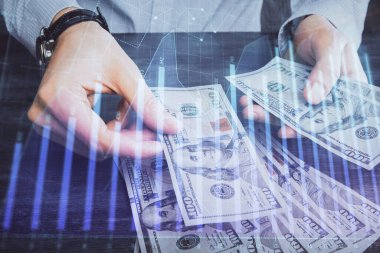 Finansal grafiğe çoklu pozlama hologram, Amerikan dolarları ve insan eli. Analiz kavramı.