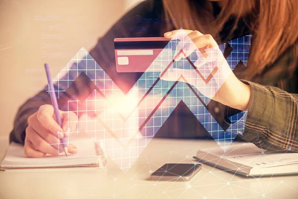 Multi exposure of woman on-line shopping holding a credit card and arrows drawing. Success concept.