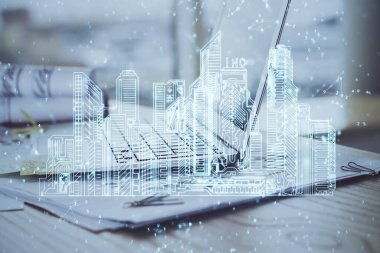 Ofisteki masaüstü bilgisayar geçmişi ve büyük kasaba binaları hologram çizimi. Çifte maruziyet. Akıllı şehir konsepti.