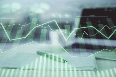 Finansal grafik çizimleri ve açık defter arkaplanı olan bir masa. Önx pazarı kavramı