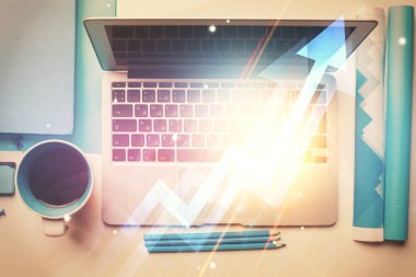 Masaüstü arkaplanındaki bilgisayarın üzerinden hologram çizimleri okluyor. Üst Manzara. Çifte maruziyet. Büyüme kavramı.