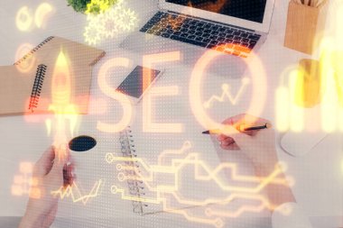Kadın elinin SEO simgesiyle notlar alırken çoklu pozlanması. Arama motoru optimizasyonu kavramı