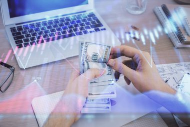 Finansal grafiğe çoklu pozlama hologram, Amerikan dolarları ve insan eli. Analiz kavramı.