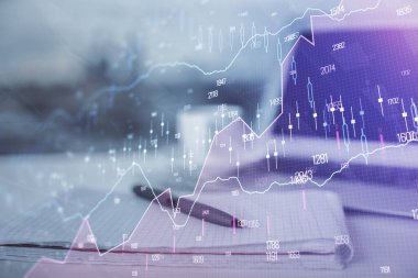 Finansal grafik çizimleri ve açık defter arkaplanı olan bir masa. Önx pazarı kavramı