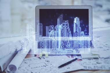 Ofisteki masaüstü bilgisayar geçmişi ve büyük kasaba binaları hologram çizimi. Çifte maruziyet. Akıllı şehir konsepti.