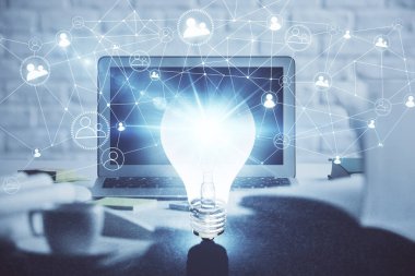 Bilgisayar ofisinde ampul simgesi hologramıyla birlikte. Çifte maruziyet. Fikir kavramı.