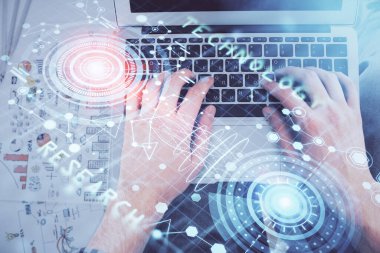 İnsan elinin bilgisayar klavyesi ve veri temalı hologram çiziminin üzerine yazarken çoklu pozlama. Üst Manzara. Teknoloji konsepti.