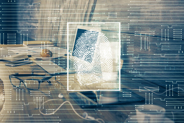 Computer on desktop in office with finger print drawing. Double exposure. Concept of business data security.