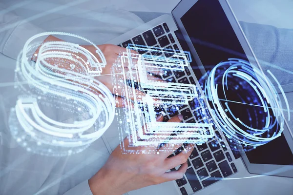 Dubbel exponering av kvinnliga händer som arbetar på dator och SEO hologram ritning. Ovanifrån. Sökoptimeringskoncept. — Stockfoto