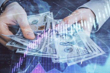 Finansal grafiğe çoklu pozlama hologram, Amerikan dolarları ve insan eli. Analiz kavramı.
