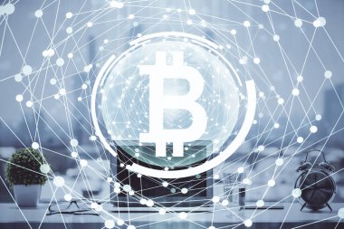 Engelleme zinciri ve kripto ekonomi temalı hologram ve bilgisayar geçmişi olan bir masa. Bitcoin kripto para kavramı.