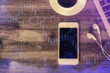 Masaüstünde telefonlu ön x grafik hologramına çift pozlama. Üst Manzara. Mobil ticaret platformu kavramı.
