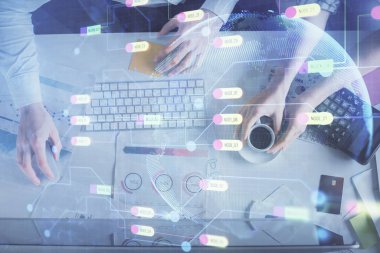 Kadın ve erkeğin birlikte çalışması ve veri temalı hologram çizimi. Bilgisayar arkaplanı. Üst Görünüm.