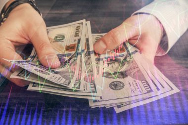 Finansal grafiğe çoklu pozlama hologram, Amerikan dolarları ve insan eli. Analiz kavramı.