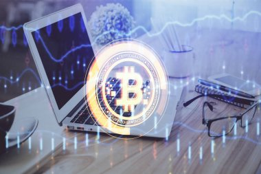 Engelleme zinciri ve kripto ekonomi temalı hologram ve bilgisayar geçmişi olan bir masa. Bitcoin kripto para kavramı.