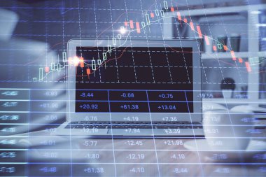 Arka planda eski pazar grafik hologramı ve kişisel bilgisayar var. Çoklu maruz kalma. Yatırım kavramı.