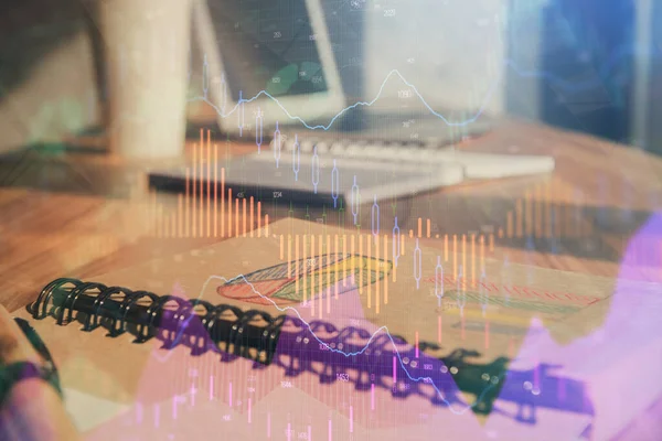 Double exposure of financial graph drawings and desk with open notebook background. Concept of forex market