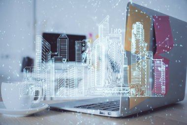 Ofisteki masaüstü bilgisayar geçmişi ve büyük kasaba binaları hologram çizimi. Çifte maruziyet. Akıllı şehir konsepti.