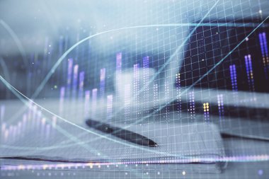 Finansal grafik çizimleri ve açık defter arkaplanı olan bir masa. Önx pazarı kavramı