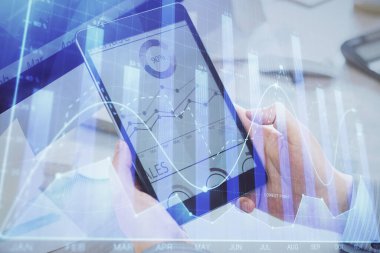 Bir adamın elini tutarken ve bir telefon ve finansal grafik çizimi kullanırken çift pozlama. Analiz kavramı.