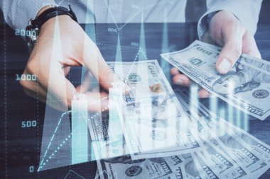 Finansal grafiğe çoklu pozlama hologram, Amerikan dolarları ve insan eli. Analiz kavramı.