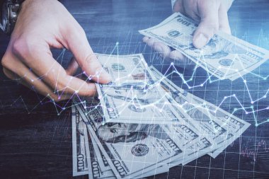 Finansal grafiğe çoklu pozlama hologram, Amerikan dolarları ve insan eli. Analiz kavramı.