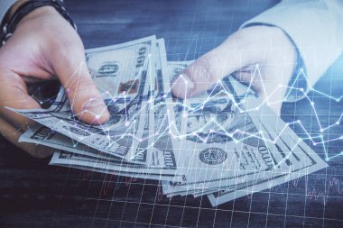 Finansal grafiğe çoklu pozlama hologram, Amerikan dolarları ve insan eli. Analiz kavramı.