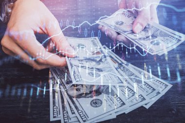 Finansal grafiğe çoklu pozlama hologram, Amerikan dolarları ve insan eli. Analiz kavramı.