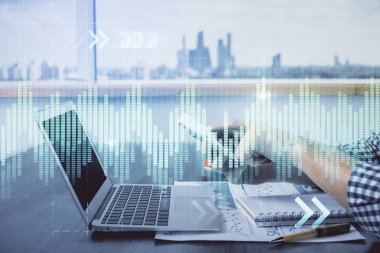 Bir adamın elini tutarken ve dijital bir cihaz ve ön grafik çizimi kullanırken çift pozlama. Finansal piyasa kavramı.