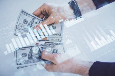 Finansal grafiğe çoklu pozlama hologram, Amerikan dolarları ve insan eli. Analiz kavramı.