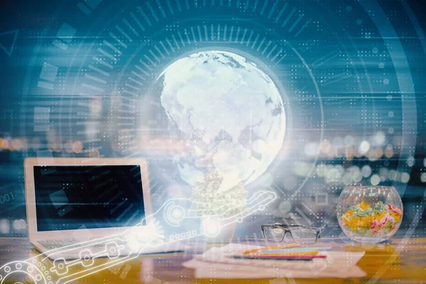 Double exposure of desktop with computer and world map hologram. International data network concept.