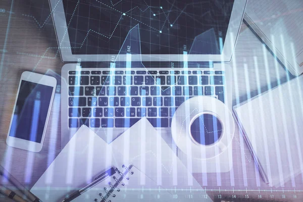 Stock market chart and top view computer on the table background. Double exposure. Concept of financial analysis.