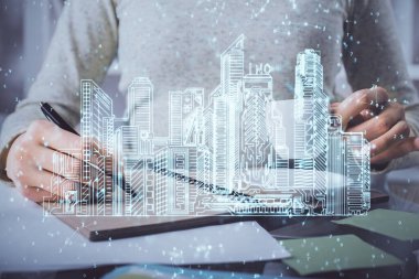 Not defterine el yazısının üzerini çiziyor. Akıllı ev kavramı. Çoklu pozlama