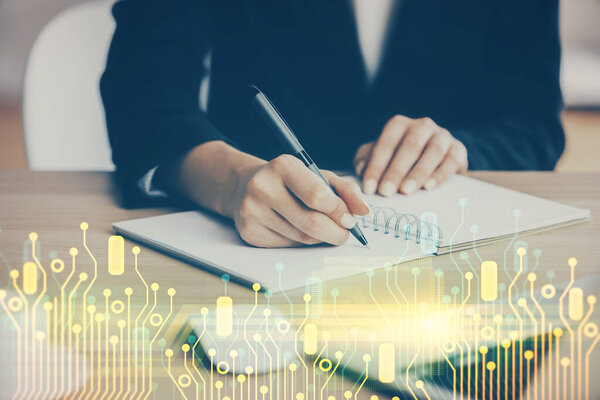 Double exposure of writing hands on background with data solution hologram on front. Technology concept. Close up