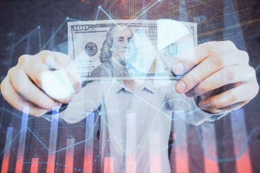 Finansal grafiğe çoklu pozlama hologram, Amerikan dolarları ve insan eli. Analiz kavramı.