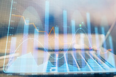 Finansal grafik renkli çizimler ve arka planda bilgisayar olan tablolar. Çifte maruziyet. Uluslararası pazarlar kavramı.