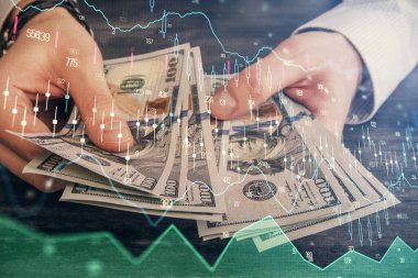 Finansal grafiğe çoklu pozlama hologram, Amerikan dolarları ve insan eli. Analiz kavramı.